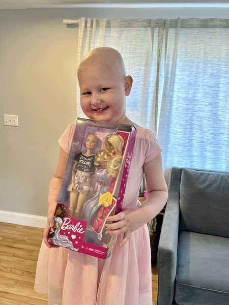 Chloe holds her Brave Barbie