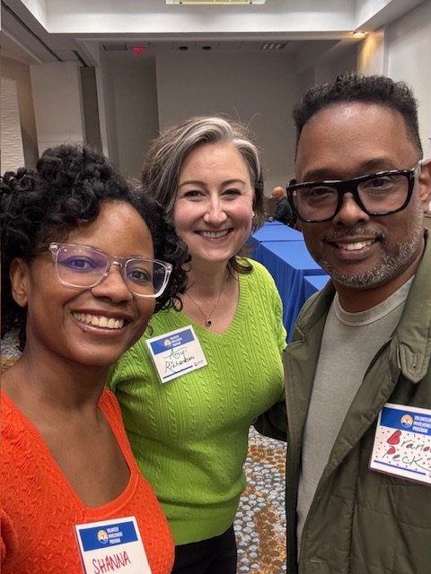Three CureSearch volunteer leaders smiling at an event
