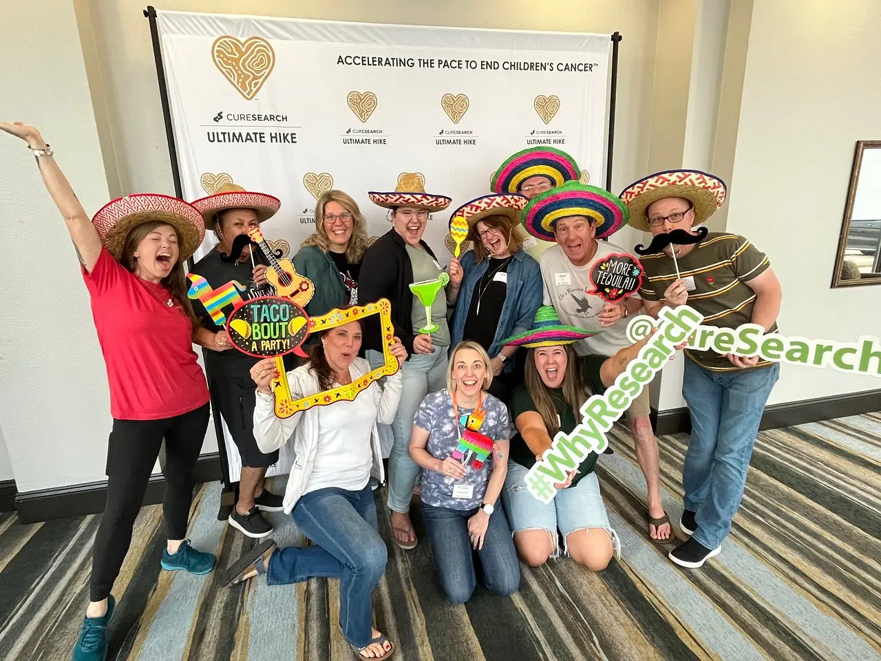 Central Texas Ultimate Hike participants in sombreros and props at a team celebration