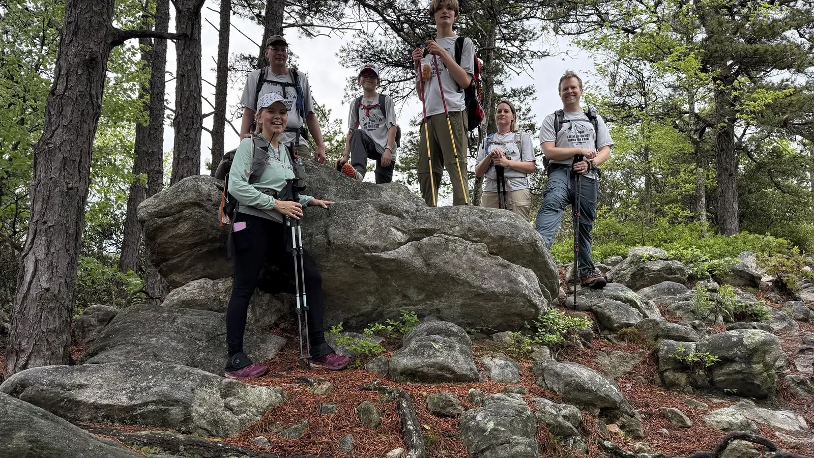 Shenandoah Valley Ultimate Hike participants on a rocky outcrop in the woods