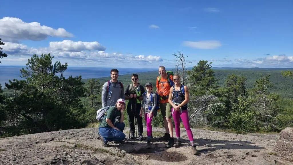 Superior Hiking Trail Ultimate Hike participants on a ridge overlooking the forest
