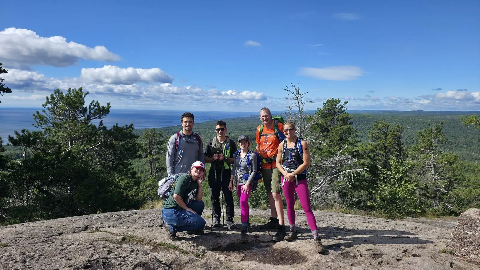 Superior Hiking Trail Ultimate Hike participants on a ridge overlooking the forest