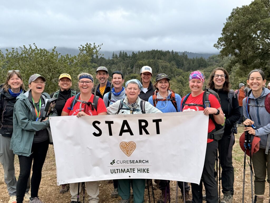 Hikers holding the CureSearch Ultimate Hike START banner in California
