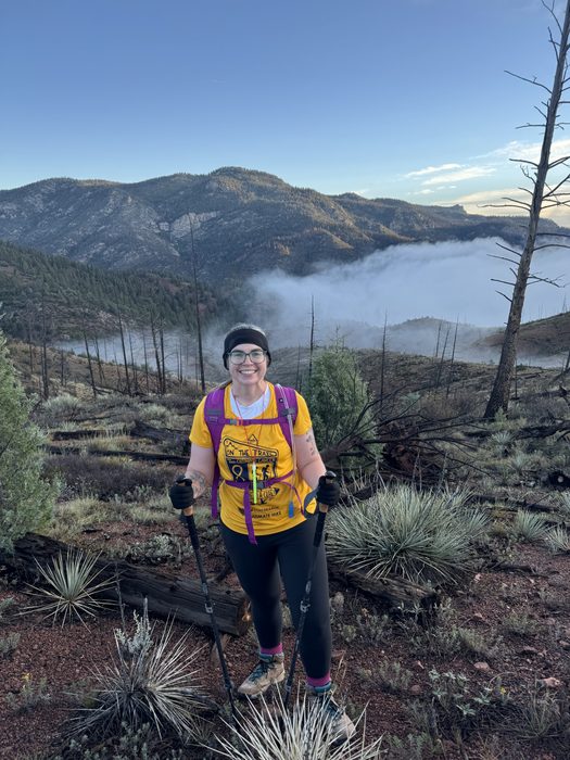 A hiker above the clouds on a Colorado ridge