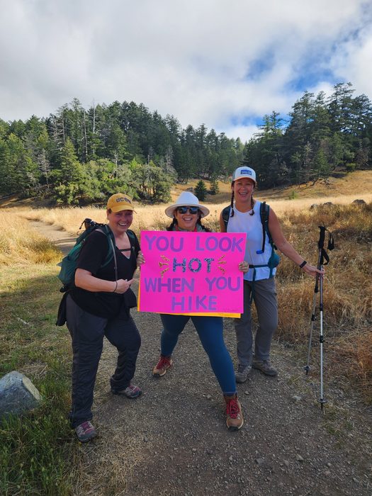 Hikers with a handmade cheering sign on a California trail