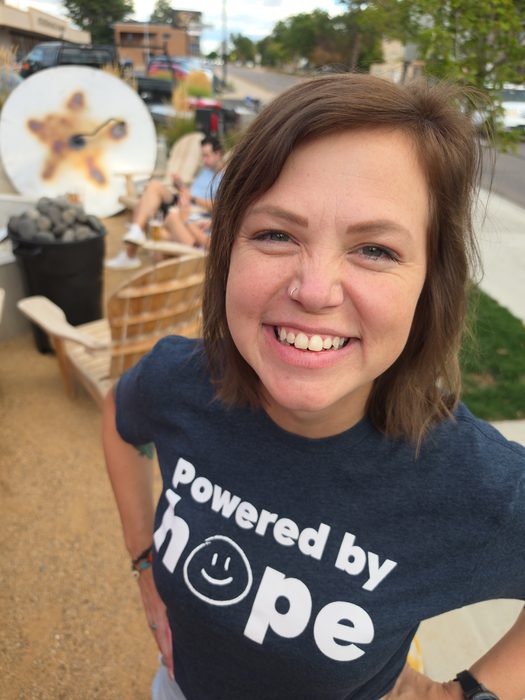A smiling participant in a Powered by Hope shirt