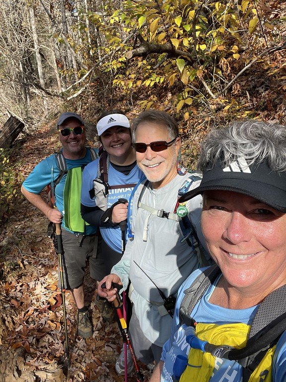 Four smiling hikers taking a selfie on the Foothills Trail