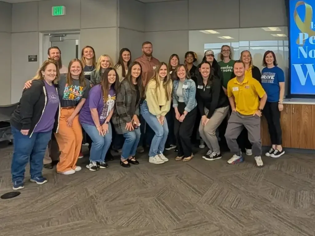 Volunteers gather in front of a welcome screen at the first annual Pediatric Cancer Non-profit Summit