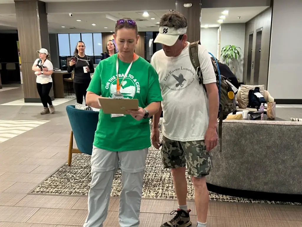 Ultimate Hike volunteer checking in a hiker