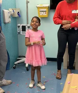 Amari happy in a pink dress