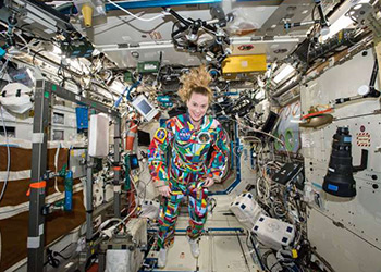 Astronaut Kate Rubins wears suit painted by pediatric cancer patients