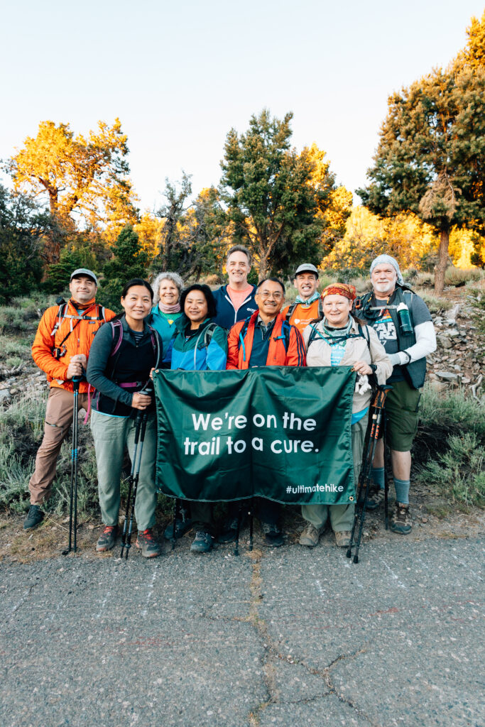 Ultimate Hike_Pacific Crest Trail_Banner Ultimate Hike participants on the Pacific Crest Trail hold up a large banner that reads 'We're on the trail to a cure".